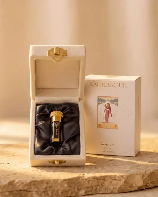 The blue and gold Inner Sanctum attar bottle on black satin in its open cream case, beside the carton reading Sacrasoul, Sanctum Attar, 3 ml.