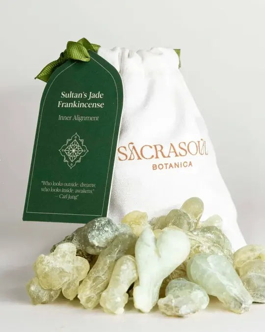 Sultan's Jade Frankincense tears, pale green and gold, heaped before a Sacrasoul Botanica pouch with its deep green Inner Alignment tag.